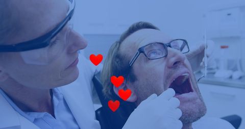 Dentist Treating Patient with Heart Graphics Overlay