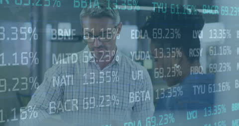 Diverse Coworkers Analyzing Stock Market Infographics in Modern Office