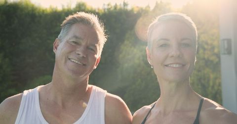Happy Senior Couple Enjoying Sunny Day Outdoors in Backyard Garden