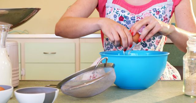 Woman baking in kitchen wearing colorful floral apron - Download Free Stock Images Pikwizard.com