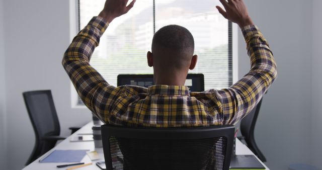 Man Celebrating Success in Office with Raised Hands - Download Free Stock Photos Pikwizard.com