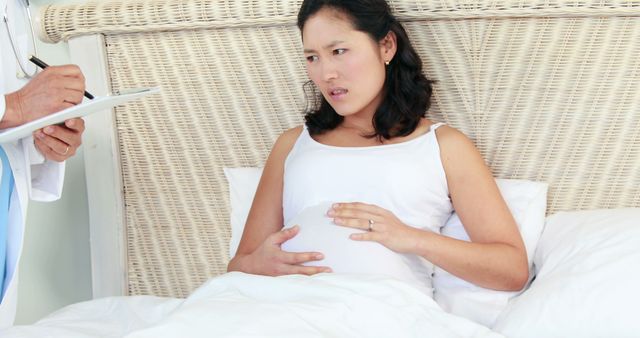 Pregnant Woman in Hospital Bed Consulting with Doctor - Download Free Stock Images Pikwizard.com