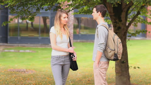 Young Students Engaging in Friendly Conversation on Campus