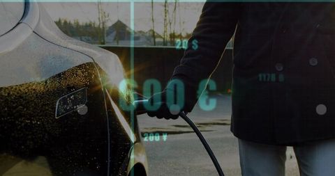Charging Electric Car at Sunset with Economic Data Overlay