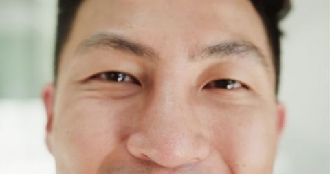 Close-up of smiling asian man, capturing joyful expression