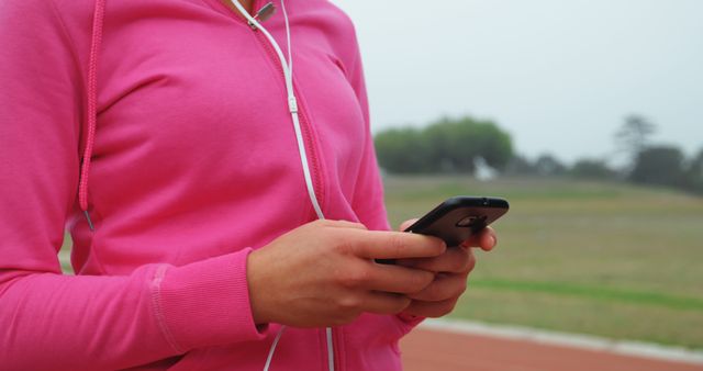 Woman in Pink Hoodie Using Smartphone Outdoors - Download Free Stock Images Pikwizard.com