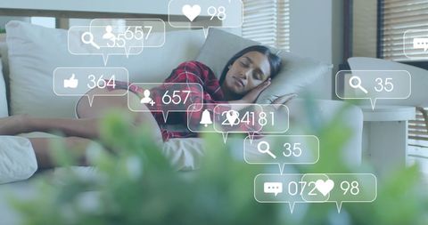 Young woman sleeping amidst floating social media icons