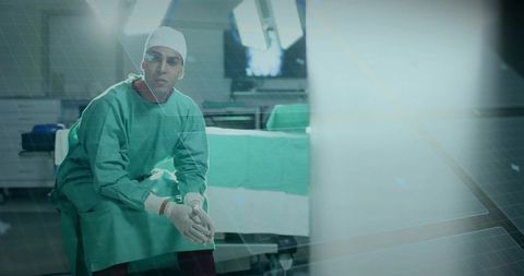 Surgeon contemplating future surgery in operating room