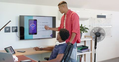 Diverse Male Coworkers Collaborating on Digital Design Project in Office
