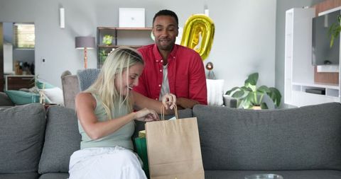 Couple Celebrating Special Occasion with Surprise Gift