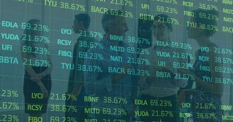 Business colleagues analyzing projected stock data in modern office