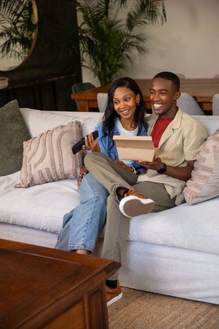 Happy Couple Enjoying Relaxing Time on Living Room Couch