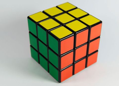 Solved rubik's cube with yellow, green, and orange sides