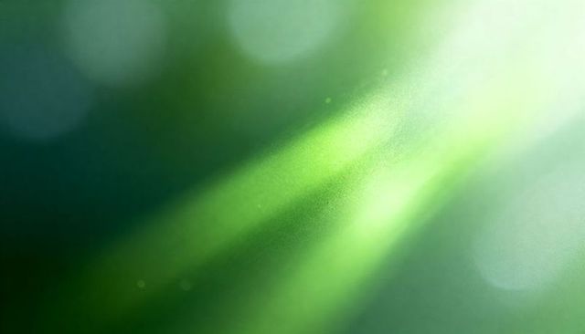 Ethereal diagonal green sunlight rays with soft bokeh, lens flare and dust