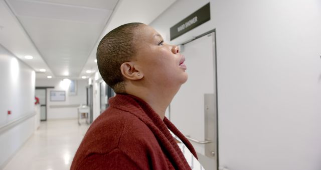 Worried Person in Hospital Corridor Gazing at Door - Download Free Stock Images Pikwizard.com