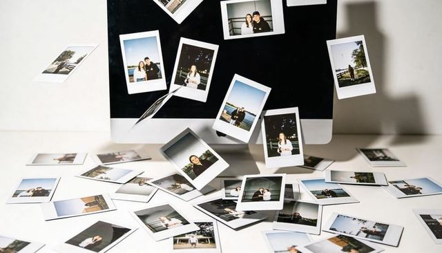 Floating polaroid prints hovering over minimal desk with monitor creating nostalgic collage