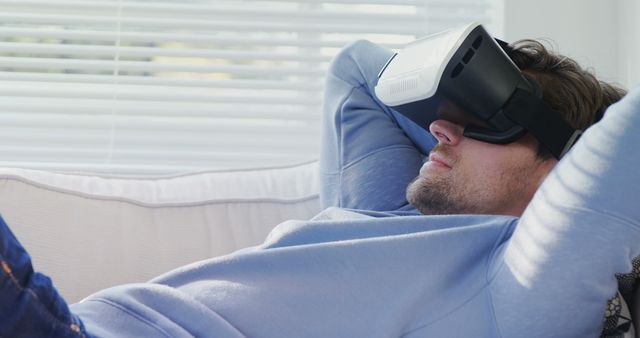 Man Relaxing on Couch with Virtual Reality Headset - Download Free Stock Photos Pikwizard.com