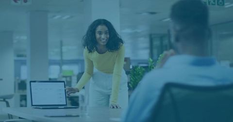 Collaborative Office Meeting with Data Presentation on Laptop