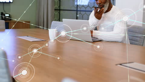 Businessman Engaging in Modern Communication With Laptop and Smartphone