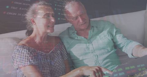 Mature Couple Analyzing Stock Market Data on Laptop at Home