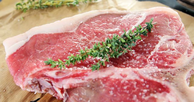 Raw Beef Steak with Fresh Thyme Sprigs on Butcher Paper - Download Free Stock Images Pikwizard.com