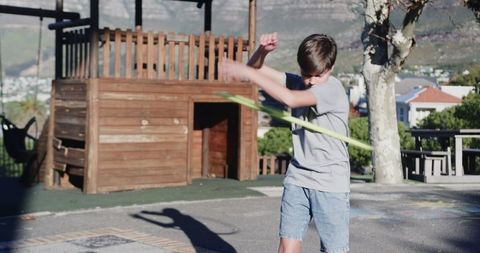 Energetic Boy Hula Hooping Outdoors During Daytime