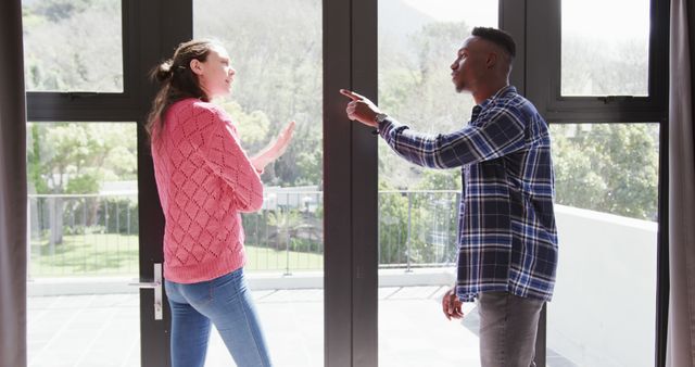 Angry diverse couple arguing by window at home, slow motion - Download Free Stock Photos Pikwizard.com