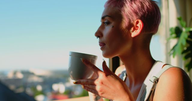 Person with Pink Hair Relaxing and Drinking Coffee by Window - Download Free Stock Images Pikwizard.com