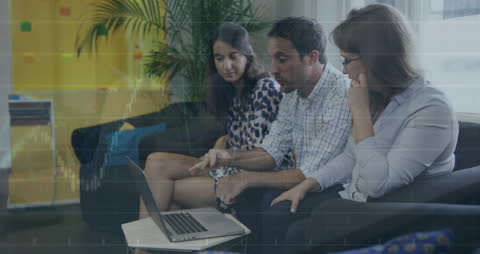 Diverse Team Analyzing Financial Charts on Laptop