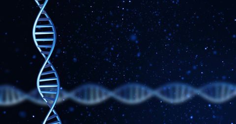 Glowing dna strands on dark background illustrating genetic engineering