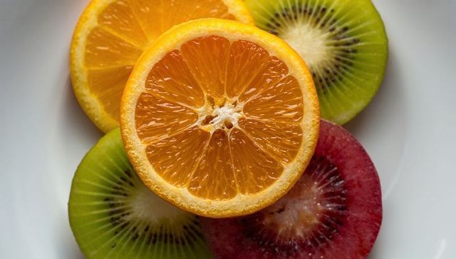 Vibrant sliced fruits on white ceramic plate representing fresh produce and culinary delight