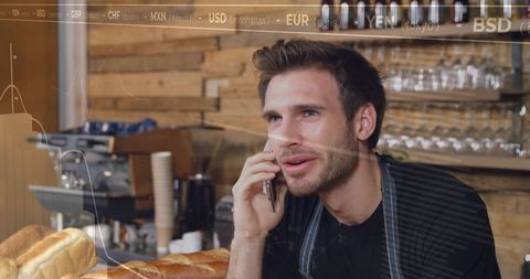 Barista talking on phone behind counter with fresh bread and espresso machine overlay