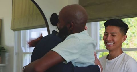 Groom engaging in lively chat with friend at wedding celebration
