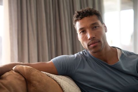 Calm Man Relaxing on Sofa in Cozy Living Room Setting