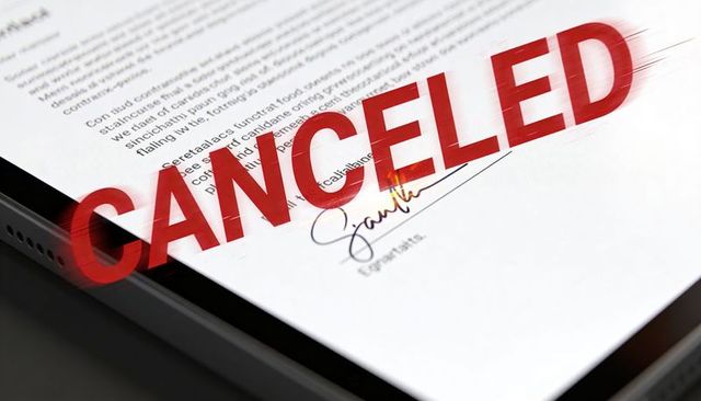Contract on tablet displaying red canceled stamp over signed agreement