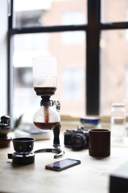 Modern Coffee Brewing with Siphon on Wooden Table by Window - Download Free Stock Images Pikwizard.com