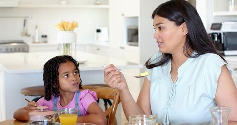 Mother and Daughter Breakfast Bonding in Modern Kitchen
