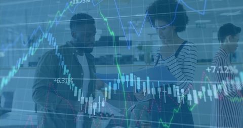 Colleagues collaborating with digital graphs overlay in modern office