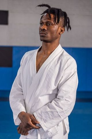 Determined martial artist preparing in dojo
