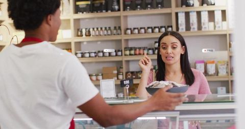 Customer Choosing Gourmet Bowl at Deli Counter Interior