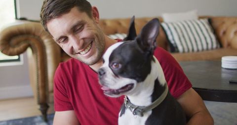 Man Enjoying Leisure Time with Pet Dog at Home