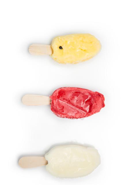 Vibrant image showcasing three different flavors of ice lollies on a white background. Useful for advertisements for summer products, food blogs, or ice cream brands. Ideal for social media posts, marketing materials, and recipe websites.