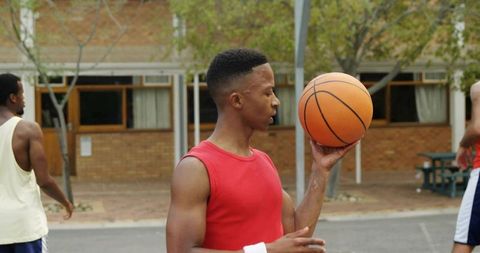 Basketball Player Balancing Ball on Finger Outdoors