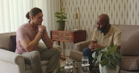Two men having serious conversation in modern living room
