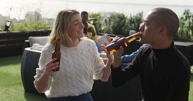 Diverse Friends Enjoying Beers on Roof Terrace During Sunny Afternoon - Download Free Stock Images Pikwizard.com