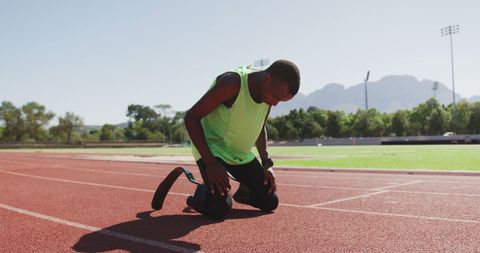 Motivated Athlete with Prosthetic Legs Preparing to Sprint - Download Free Stock Images Pikwizard.com