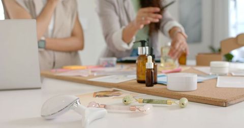 Wellness and skincare product development team testing jade rollers, serums, swatches
