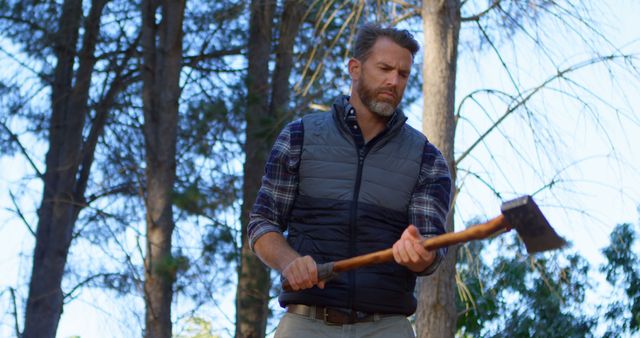 Man chopping wood with axe in forest - Download Free Stock Images Pikwizard.com