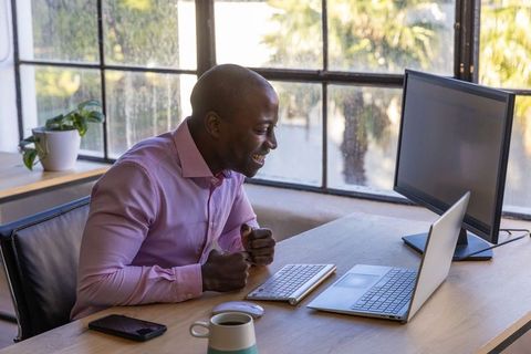 African American Professional Experiencing Joy at Work in Modern Office Environment
