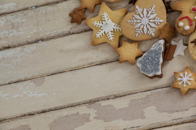 Assorted Christmas cookies with festive decorations including snowflakes, stars, and gingerbread on rustic wooden surface. Ideal for holiday-themed promotions, baking blogs, Christmas greeting cards, festive recipe books, and social media posts celebrating winter holidays.